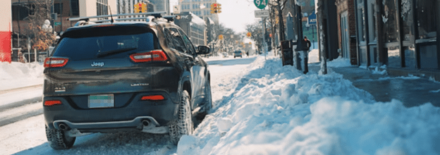 SUV parked on a snowy city street, tire tracks visible. Snow piled on sidewalk.