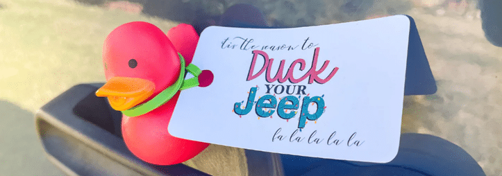 Rubber duck on a Jeep with a tag reading "‘tis the season to Duck Your Jeep la la la la."